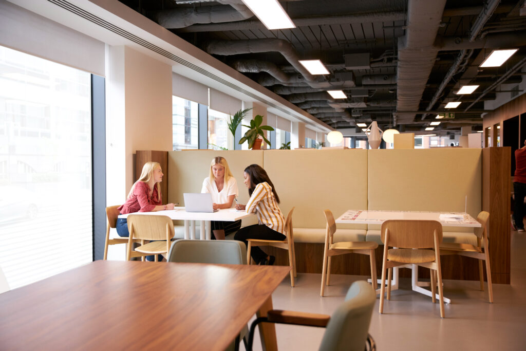 two women talking at an office.